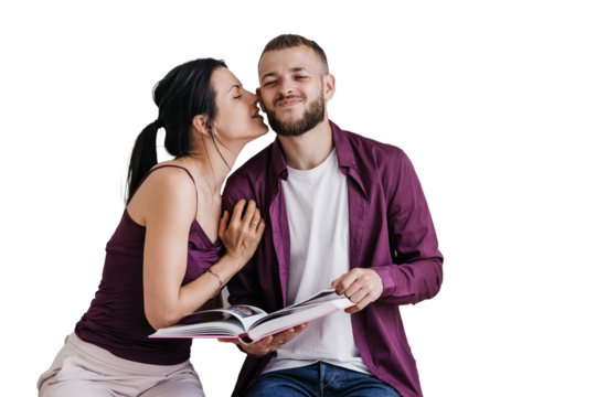 Romantic moment as a woman kisses her partner's cheek while he reads a book, both dressed in matching maroon outfits. Isolated on transparent background