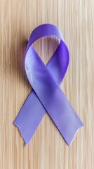 Elegant purple ribbon symbolizing cancer awareness on a light wood background, showcasing contest-winning product photography with high detail