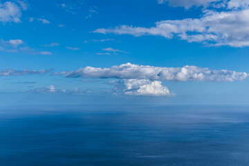 View of the blue Atlantic and white clouds from the glass-floored Cabo Girao lookout on Madeira Island