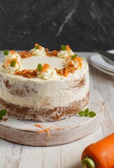 Gluten free whole pineapple carrot cake decorated with ermine frosting and chopped almond. Close up. Selective focus.