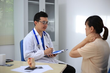 Fototapeta premium Male doctor with experience examining young pregnant women
