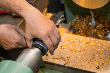 The machine operator set up the drill tool on lathe machine.