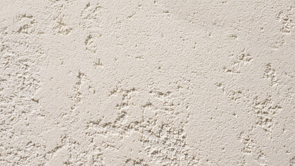 Fototapeta premium Beige exterior plaster background. Single-layer glued walls made of cement plaster. Facade of the structure, silicate sand cement plaster.