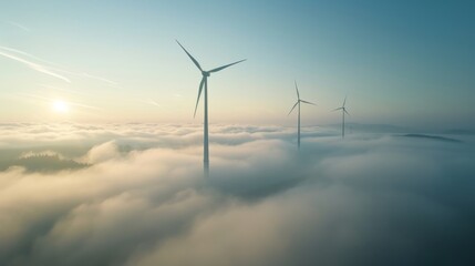 Wind turbines in silhouette during a foggy morning