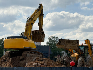 Building destruction, demolition of a building by an yellow excavators