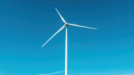 Fototapeta premium A towering wind turbine standing against a clear blue sky