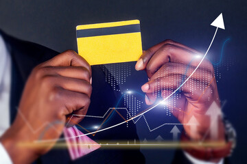 A man holding a credit card with a black stripe and a yellow stripe