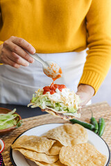 mexican tostadas with chicken, woman cooking traditional homemade food in Mexico Latin America	