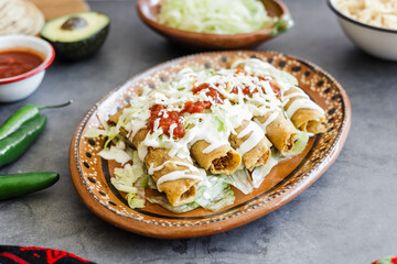 Mexican tacos dorados called flautas with chicken, traditional fried food in Mexico Latin America	
