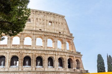 Obraz premium Rome, Italy - April 09, 2024: Ruins of the Coliseum with tourists strolling among the archaeological remains in Rome, Italy