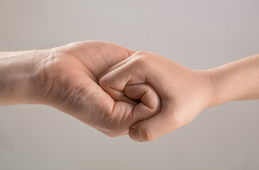 Male and child hands connected each other together and forever. Friendly handshake, friends greeting. Rescue, helping hand. Man help hands, protection. Woman and kid hands connect with each other