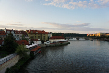 Fototapeta premium A river through the city at evening