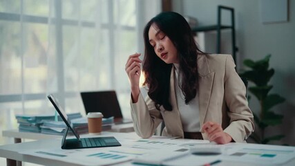 Businesswoman overwhelmed with paperwork, dealing with stress and fatigue at her desk in a modern office, highlighting the challenges and pressures of a corporate job