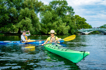 Active outdoor lifestyle: Sea kayakers having fun on long pond in the toronto island in summer, room for text