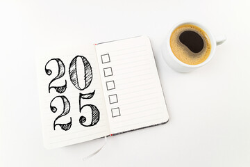 New year resolutions 2025 on desk. 2025 goals list with notebook, coffee cup on white. Resolutions, plan, goals, action, checklist, idea concept. New Year 2025 resolutions, copy space