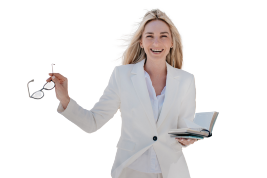 Cheerful blonde woman in a white suit, holding glasses and an open notebook, smiling confidently. Isolated on transparent background