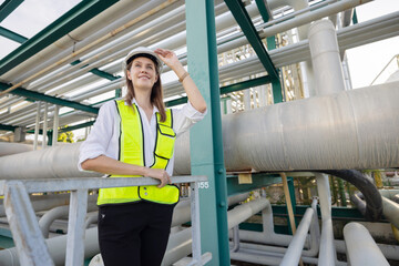 Female petroleum engineer working at oil refinery site