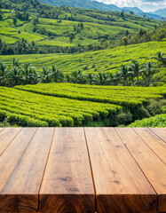 Empty wooden table or wooden desk with tea plantation nature background with green leaves as frame Product display natural background concept