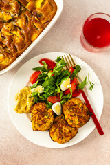 Savor a balanced and appetizing breakfast of zucchini pancakes with fresh lettuce and tomatoes, accompanied by cherry compote and a delightful peach pie for a satisfying morning meal