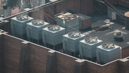 A large industrial building with a large cooling tower on top