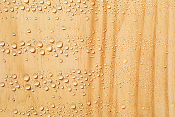 Water drops on wooden surface, close-up