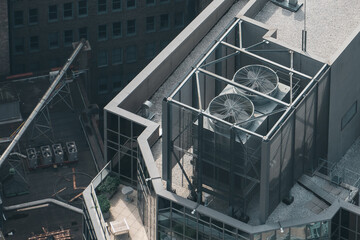 A large industrial building with a large cooling tower on top