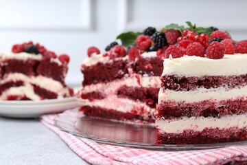 Tasty sponge cake with different berries on light grey table, closeup