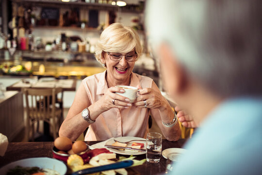 Senior couple eating food in cozy restaurant bistro
