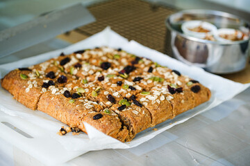 banana bread. this banana bread is homemade, i used brown sugar, flour, egg and also rile bananas. the top of the bread is almond slices, raisin, nuts and oat. the taste is so good and sweet.
