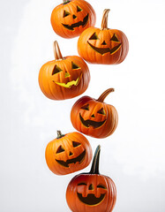 Halloween pumpkins falling freely vertically on white background
