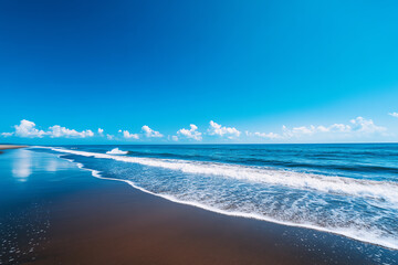 Beautiful beach with clear blue sky, gentle waves, and serene shoreline. Perfect representation of a sunny and peaceful coastal day.