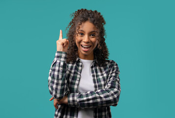 Genius creative idea, african teenager girl - eureka moment, pointing finger up