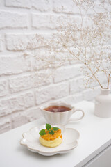 Enjoy a cup of tea and pastries on a stylish minimalist table, perfect for a cozy afternoon