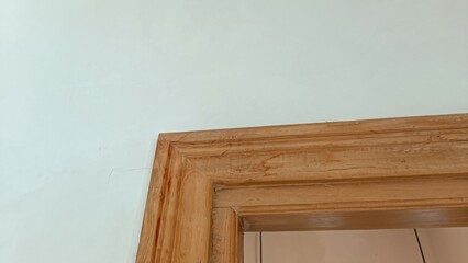 A wooden door frame with a brown stain on it