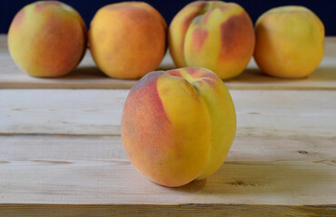 Ripe peaches on a wooden table.