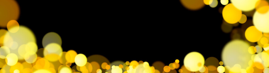 Golden highlights on a black background. Festive background. Blurred golden bokeh on a black background. New Year. Shiny gold glitter particles falling on a black background