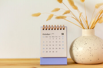 The desktop calendar for October 2024 is on the table.