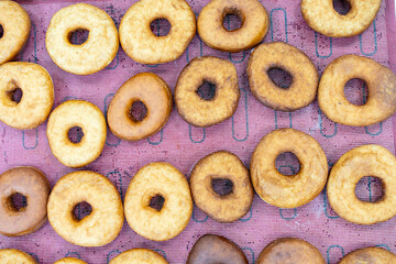Donuts laid out on a production tray. Mini donut production. Small business.