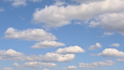  Blue sky with fluffy white cumulus clouds in summer 