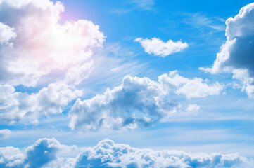 Dramatic blue sky background. Picturesque colorful clouds lit by bright morning sunlight