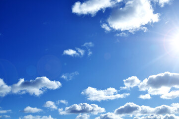 Sky background, dramatic blue sky landscape, white clouds under bright sunlight