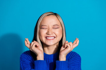 Photo portrait of lovely young lady hope make wish dressed stylish knitwear garment isolated on blue color background