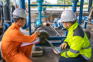 Engineer and technician maintenance checking technical data of system equipment Condenser Water pump and pressure gauge,environmentalist working at water supply