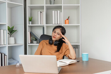 Young Woman Feeling Stressed While Studying Online at Home with Laptop and Books