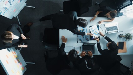Top down view of professional business team working together to share idea while using colorful...