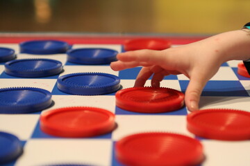 kid playing checkers 