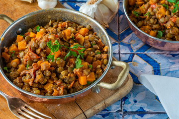Brown lentils stew with white wine, serrano ham and smoked paprika