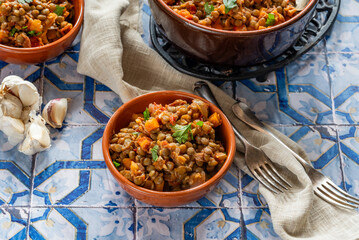 Brown lentils stew with white wine, serrano ham and smoked paprika