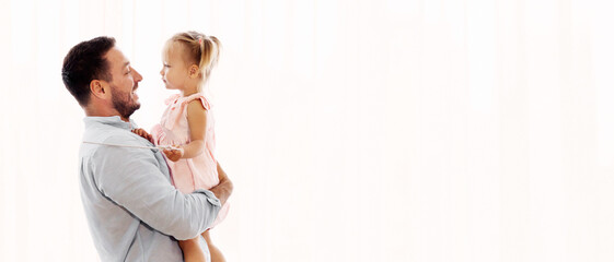 Father's Love. Happy dad holding his cute little daughter on hands, white background with copy space