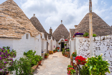 Famous historical old dry stone trulli houses with conical roofs in Alberobello, Italy.